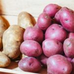 a drawer full of white and red potatoes