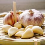 a basket full of garlic bulbs and cloves