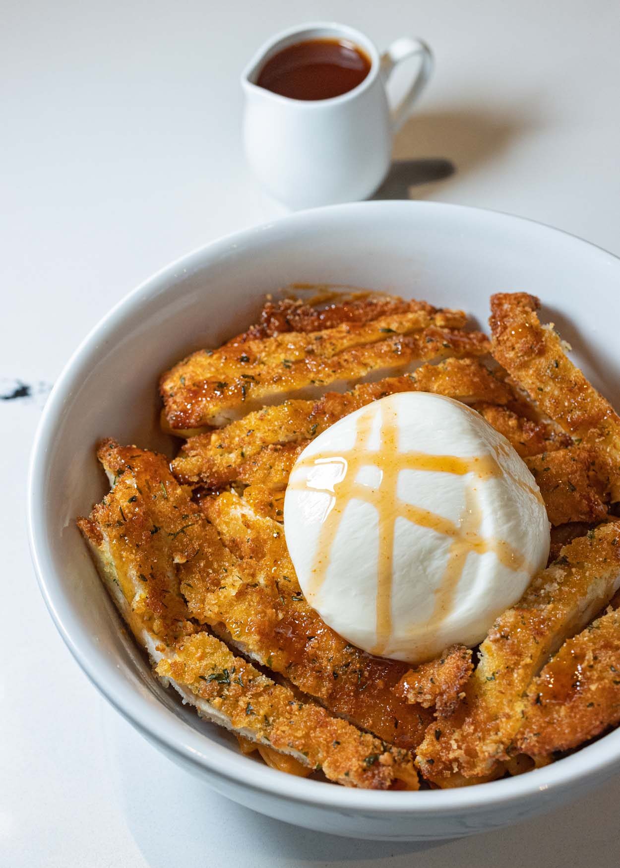 Spicy Chicken Cutlet Rigatoni at LaScala's Fire with crispy sliced chicken cutlet over rigatoni in vodka cream sauce, topped with a whole burrata and drizzled with hot honey