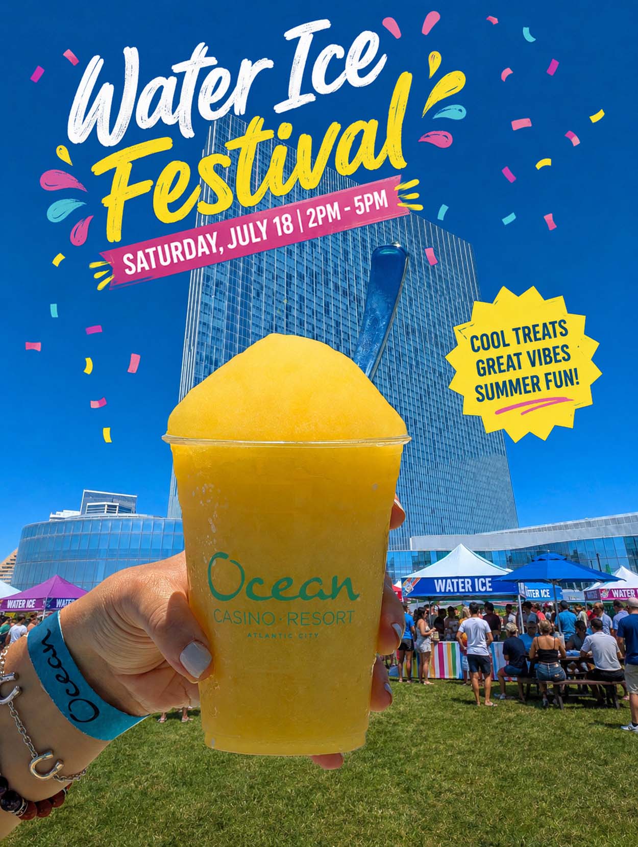 Hand holding a large mango water ice cup from Ocean Casino Resort in front of the resort tower and vendor tents at the Water Ice Festival