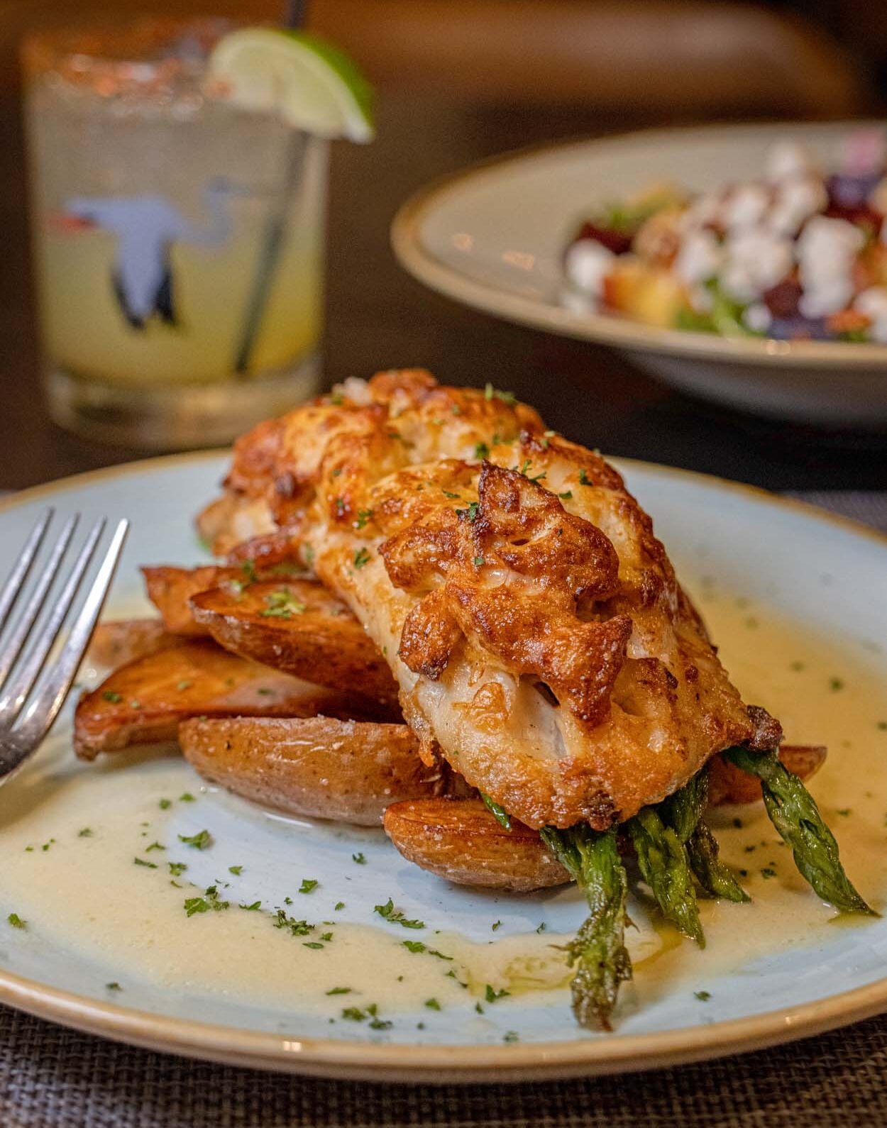 Rockfish fillet with a golden crust served over asparagus and fingerling potatoes in a light butter sauce at lak restaurant at Merriweather Lakehouse Hotel in Columbia Maryland