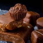 A delectable assortment of chocolate desserts including fudge and peanut clusters.