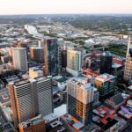 Stunning aerial cityscape of Nashville, Tennessee featuring skyscrapers and urban layout at sunset.