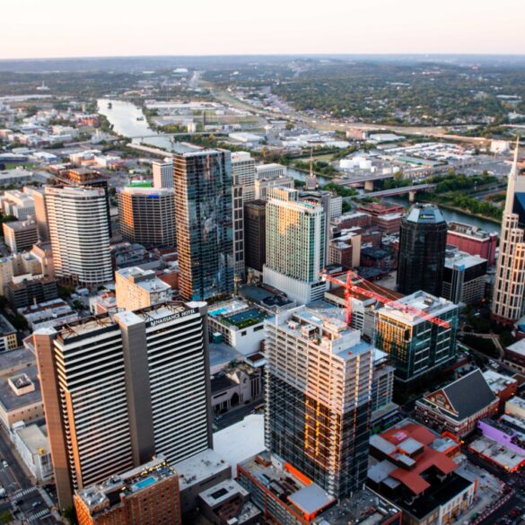 Stunning aerial cityscape of Nashville, Tennessee featuring skyscrapers and urban layout at sunset.