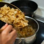 do bonito flakes go bad? Cooking Japanese dashi stock with bonito flakes on a stove for authentic Asian cuisine