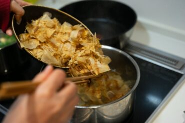 do bonito flakes go bad? Cooking Japanese dashi stock with bonito flakes on a stove for authentic Asian cuisine