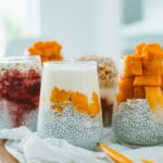 Delicious chia pudding parfaits topped with vibrant, fresh fruits and yogurt.