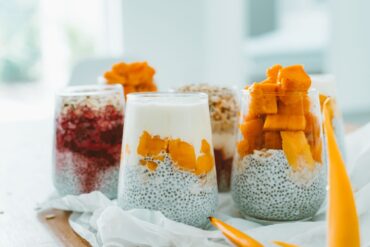 Delicious chia pudding parfaits topped with vibrant, fresh fruits and yogurt.