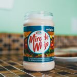 an open jar of miracle whip on a tiled counter