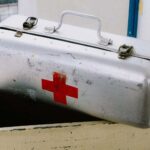 an old metal first aid kit in storage, possibly filled with expired items