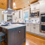 Spacious modern kitchen with wooden accents and an island countertop.