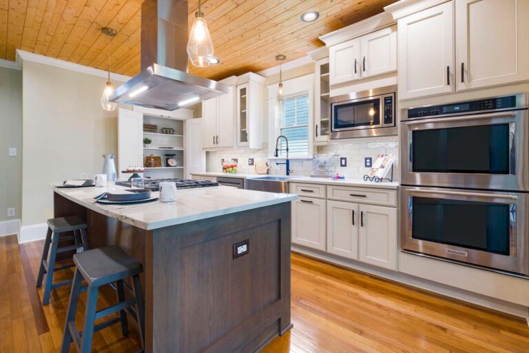 Spacious modern kitchen with wooden accents and an island countertop.