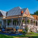 Roofers replace the roof of a historic home