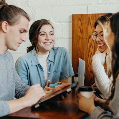 a group of young college students having a fun conversation at a dining table