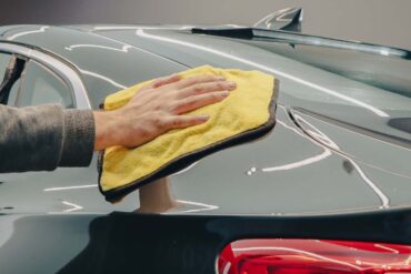 a person hand waxing their car with Turtle Wax