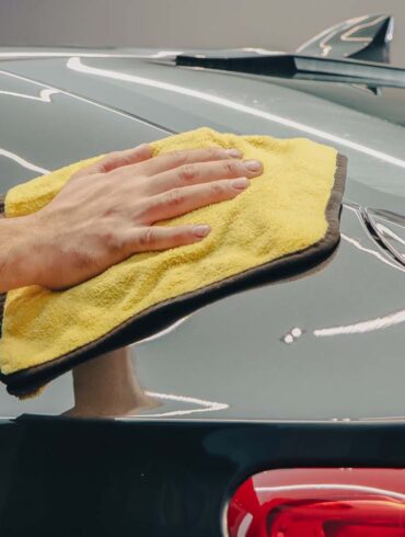 a person hand waxing their car with Turtle Wax