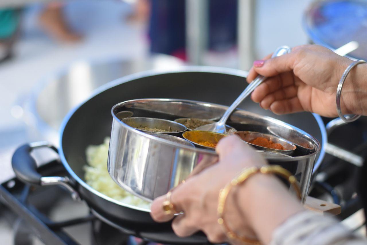 Woman cooking a traditional Indian meal in a home kitchen