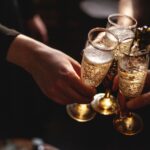 a close up of 3 people toasting champagne in a party setting