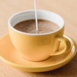 Coffee-Mate being poured into a fresh cup of coffee