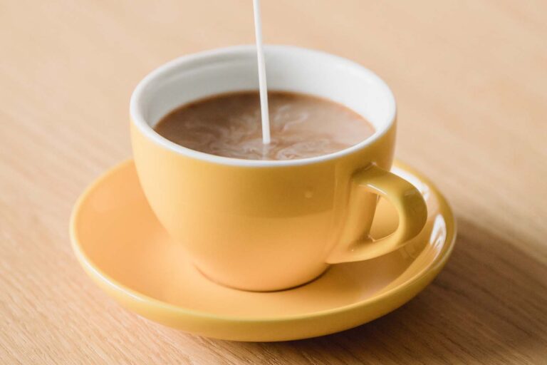 Coffee-Mate being poured into a fresh cup of coffee