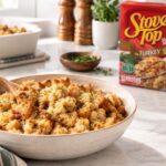 a prepared bowl of stove top stuffing with the box in the background. a clean and bright kitchen counter setting