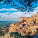 Panoramic view of Volterra's historic architecture and scenic landscape under a clear sky
