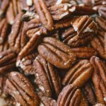 close up shot of shelled pecans laid out on a table